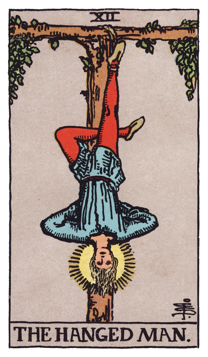 The Hanged Man: A man hangs by one foot from a living wooden frame; his free leg bends and a halo surrounds his head.